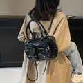 Glossy black bow-knot backpack with white contrast stitching and oil wax leather finish - Black
