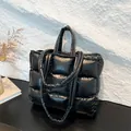 Large black quilted tote bag in glossy down-style fabric with hand and shoulder straps - Black