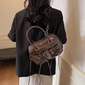 Dark brown oil wax leather bowling bag with bow decoration and crossbody strap - Brown
