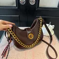 Dark brown crescent underarm bag with glossy finish and gold chain strap accent - Coffee with Pendant