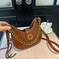 Brown crescent shoulder bag with gold chain strap and vintage leather finish - Brown with Pendant