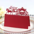 Elegant red laser cut wedding place card featuring a royal carriage and horse design - Pearlescent Red