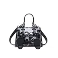 Detail view of the mini Kelly bag featuring a cartoon face design and animal patterns - Black