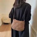 Caramel brown quilted crossbody bag with diamond stitch and woven knots detail - Brown