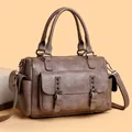 Vintage brown leather crossbody bag with rivet details and spacious interior - Camel