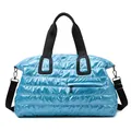 Glossy blue puffer gym bag with quilted design and detachable black shoulder strap - Sky Blue