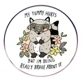 Cartoon raccoon enamel pin with My Tummy Hurts message and colorful floral accents - Cartoon Raccoon Style