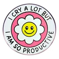Round enamel pin with I CRY A LOT BUT I AM SO PRODUCTIVE text and yellow smiley flower - Pink And White (Productive)