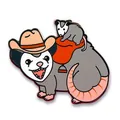 Cowboy opossum enamel pin featuring a small possum on a red saddle with metal edges - Cowboy Screaming Opossum