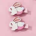 Detail of pink glitter bunny hair clips with soft pompom tails and ribbon wrapped clips - Little Rabbit Style / 2-Piece Set