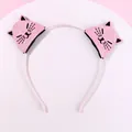 Detailed view of pink sequin cat ears on a non-slip headband for little girls - Pink Cat