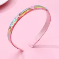 Rainbow sequin headband with pink heart and star charms on a soft pink background - Multicolor Sequin Headband
