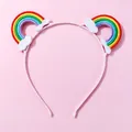 Pink kids headband with embroidered rainbow and cloud patches on a soft pastel base - Embroidered Rainbow Headband