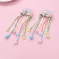 Detailed view of rainbow sequin hair clips with long tassels and glitter star accents - Sequin Rainbow Tassel Hair Clip