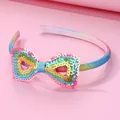 Rainbow gradient girls headband with sparkling sequined heart bow on a pink backdrop - Rainbow Sequin Style