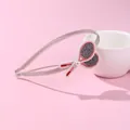 Detail of grey fabric headband with embroidered tennis rackets and a small pearl accent - Tennis Racket Style