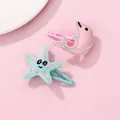 Sparkly glitter dolphin and starfish hair clips set for girls on a pink background - Starfish And Dolphin Hair Clips