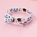 Detail of preppy style headband with double-layered bow and graduation party patterns - Graduation Cap Style
