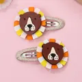 Detail of handmade cartoon lion hair clips with brown leather face and ribbon mane accents - Orange Yellow Mane Lion (Gold Clip)