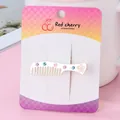 Silver comb-shaped hair clip with pink and blue rhinestones on a card display - Matte Silver Comb Hch248-1