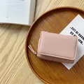 Portafoglio rosa da donna in pelle grana litchi a tre ante con cerniera e scomparti - Rosa