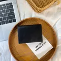 Portefeuille compact noir en cuir grainé avec fentes pour cartes et finition mate - Noir