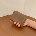 Brown faux leather short bifold wallet with BOYA'S logo and matte textured finish - Dark Brown