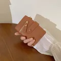 Women's minimalist brown pebble leather wallet with golden zipper and snap strap - Dark Brown