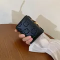 Women's black fold short wallet featuring relief bear pattern and white pompom charm - Black