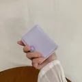 Lavender mini tri-fold faux leather wallet with 3D flower detail held in hand - Light Purple