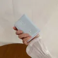 Light blue tri-fold wallet for women featuring cute ribbon bows and pearl accents - Blue