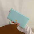 Elegant mint blue long leather wallet for women with golden logo and wrist strap - Light Blue