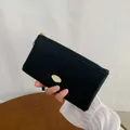 Elegant long black wallet for women with matte texture and golden oval metal logo plate - Black