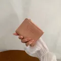 Short pink textured leather folding wallet with MOMO DOG logo and gold zipper - Deep Pink
