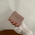 Short dusty pink folded wallet with crinkled leather texture and gold zipper detail - Lotus root pink