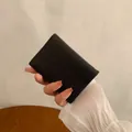 Short black litchi grain PU leather folding wallet for women with gold metal corners - Black