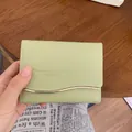 Elegante portafoglio corto verde chiaro da donna con bordo dorato ondulato e molti vani - verde chiaro