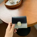 Short bi-fold wallet for women in black and light blue color block leather design - Black