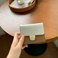 Short two-tone wallet in beige and brown faux leather with elegant golden metal buckles - Brown