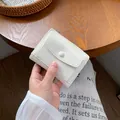 White minimalist faux leather mini wallet with wrinkled texture and zipper pocket - White