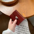 Compact wine red heart-shaped trifold wallet in vintage textured leather with silver buckle - Burgundy