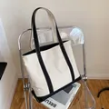 Minimalist canvas tote bag with black trim contrast and long shoulder straps - Black