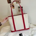 Large beige canvas tote bag with red handles and reinforced base for casual daily use - Burgundy