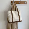 Minimalist canvas tote bag in off-white with brown leather trim and shoulder straps - Coffee