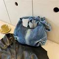 Schultertasche aus gewaschenem blauem Denim in Halbmondform mit Schleifendetail - Blau