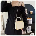 Chic white box bag with gold metal trim and woven handle for women fashion - Off White