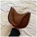 Brown quilted half-moon underarm bag with adjustable leather strap in stylish design - Brown