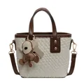 Chic cream and brown woven tote bag with dual handles and cute monkey pendant - Single Bag / Off White