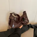 Deep brown glossy hobo bag with silver metallic eyelets and buckle shoulder strap - Brown