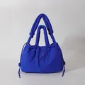 Quilted puffy tote bag in vibrant Klein blue featuring drawstring details and padded handles - Dark Blue